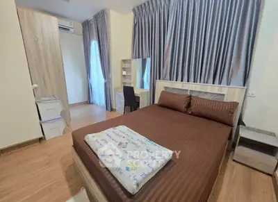 Cozy bedroom with modern furnishings and ample natural light