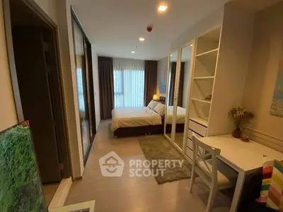 Modern bedroom with study area and large window, perfect for urban living.