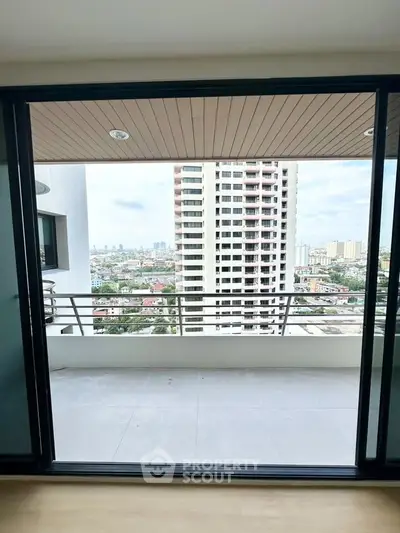 Spacious balcony with stunning city view in modern high-rise apartment