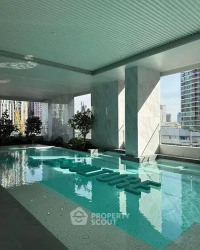 Luxurious indoor pool with city view in modern high-rise building