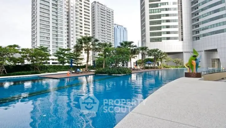 Luxurious high-rise apartment complex with stunning pool and modern architecture.