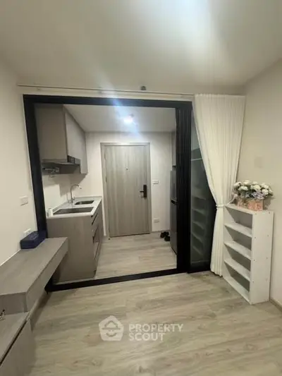 Modern compact kitchen with sleek cabinetry and open layout in a stylish apartment.