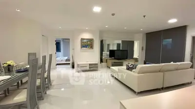 Spacious modern living room with elegant dining area and sleek furnishings