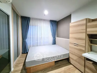 Modern bedroom with wooden furniture and large window with blue curtains