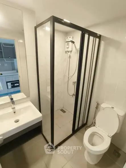 Modern bathroom with glass shower enclosure and sleek fixtures