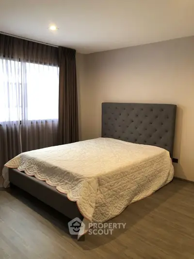 Cozy bedroom with elegant bed and natural light from window