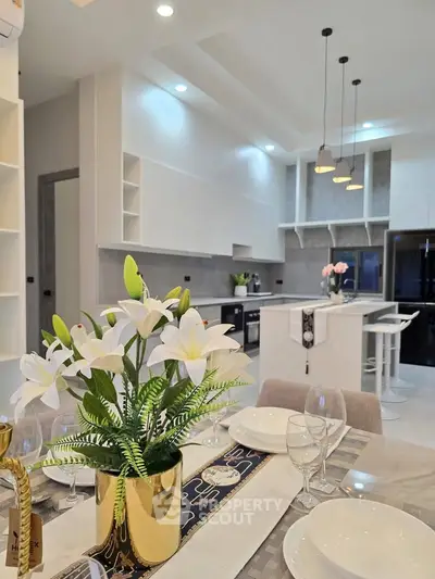 Modern open-layout kitchen with elegant dining area and stylish decor