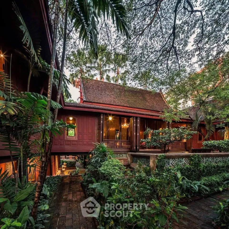 Stunning traditional wooden house surrounded by lush tropical garden