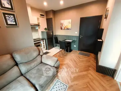 Modern living room with cozy seating and compact kitchen area