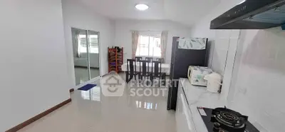 Spacious kitchen with dining area and modern appliances in a bright, open layout.