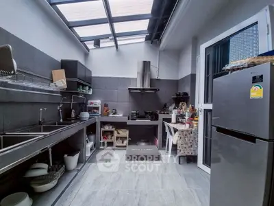 Modern kitchen with skylight, sleek appliances, and ample storage space.