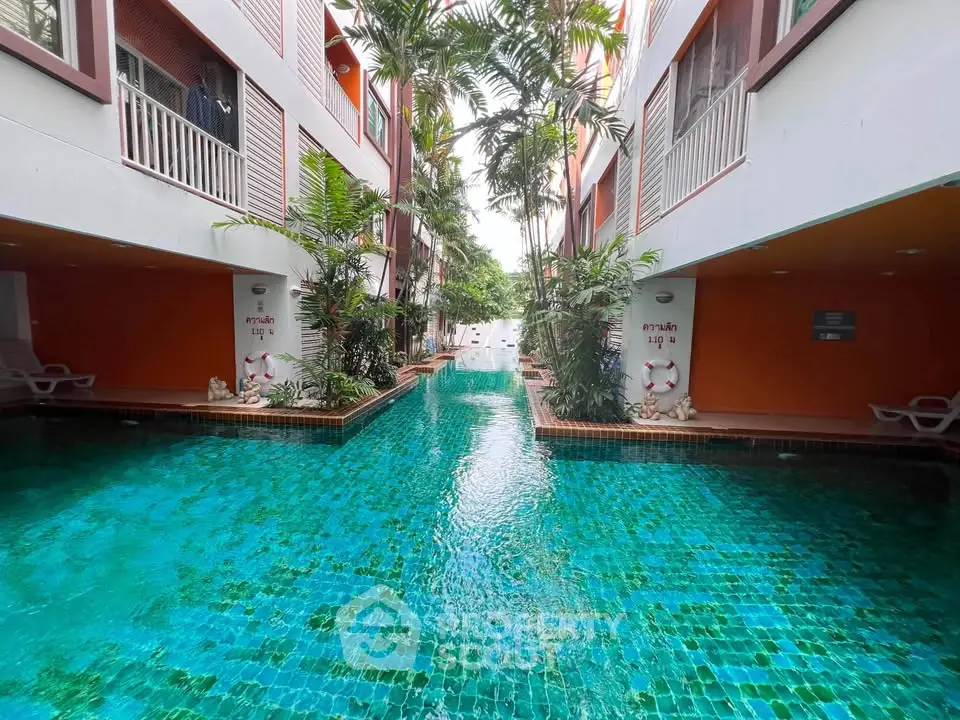 Luxurious apartment complex with stunning pool and lush greenery, perfect for relaxation and leisure.
