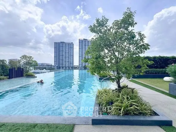 Luxurious rooftop pool with stunning cityscape view and lush greenery