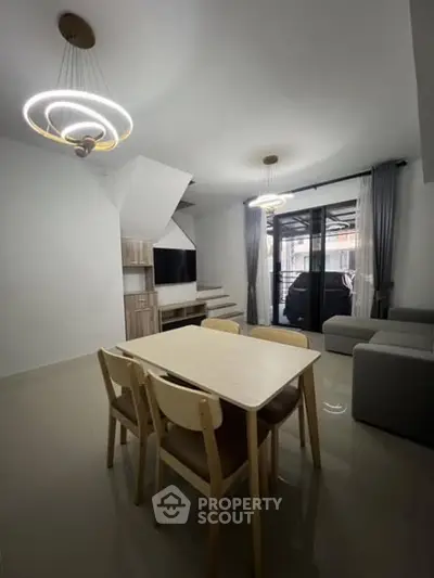 Modern living room with stylish lighting and dining area