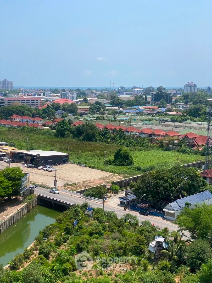 Stunning aerial view of suburban landscape with lush greenery and distant city skyline.