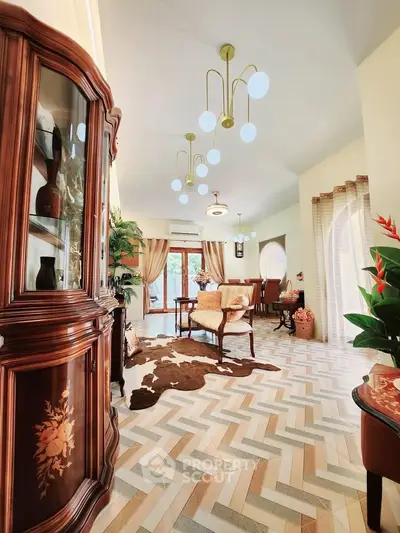 Elegant living room with stylish furniture and unique lighting, featuring a cozy dining area and decorative flooring.