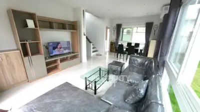 Spacious living room with modern furniture and large windows for natural light.