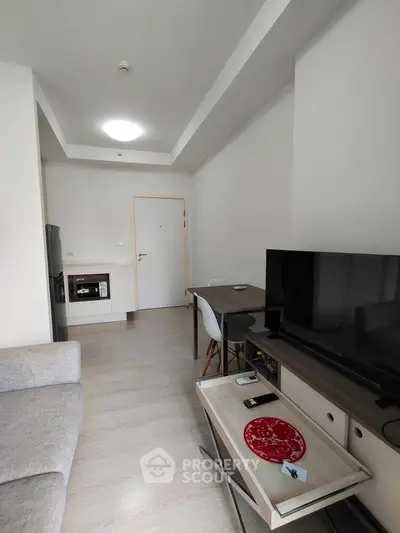 Modern living room with sleek furniture and open kitchen layout