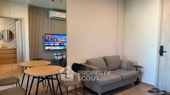 Modern living room with stylish furniture and wall-mounted TV, perfect for cozy gatherings.