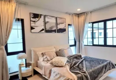 Luxurious bedroom with elegant decor and large windows for natural light