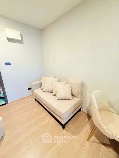 Cozy minimalist living room with beige sofa and wooden flooring