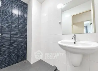 Modern bathroom with sleek white tiles and stylish sink design