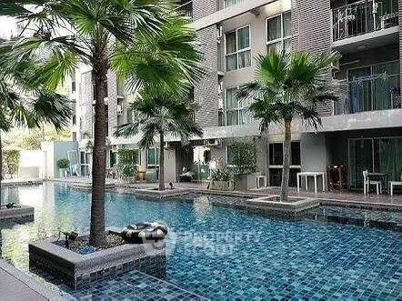 Luxurious apartment complex with stunning pool and palm trees