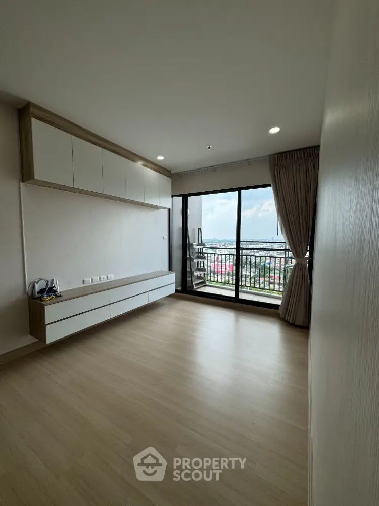 Spacious living room with large balcony and scenic view