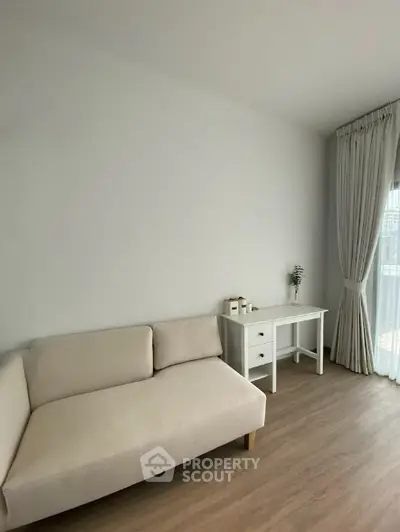 Modern minimalist living room with beige sofa and natural light