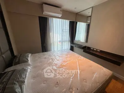 Modern bedroom with large window and air conditioning in stylish apartment.