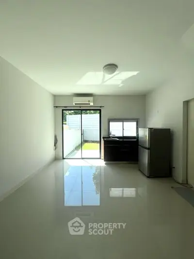 Bright minimalist kitchen with garden view and sleek appliances