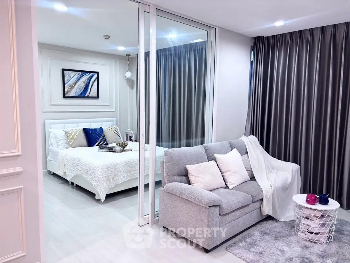 Modern studio apartment with cozy living area and elegant bedroom