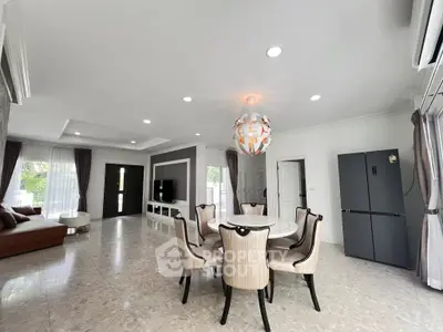 Spacious modern living room with elegant dining area and large windows for natural light.