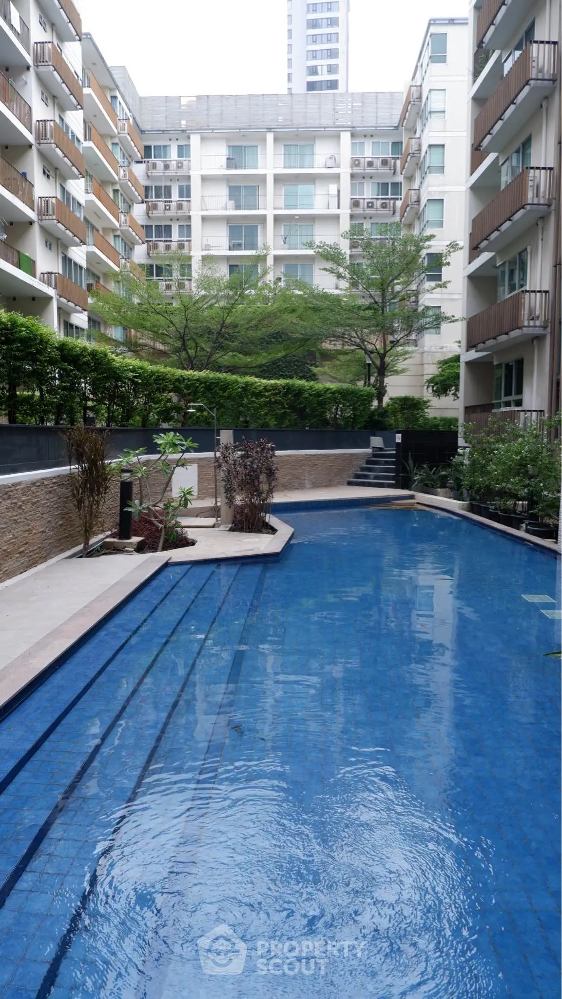 Luxurious residential complex with a stunning outdoor pool and modern architecture.