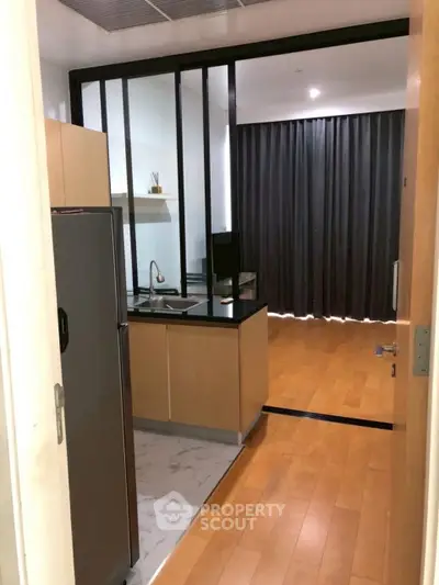Modern kitchen with sleek design and wooden flooring