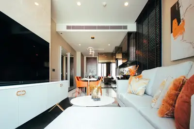 Luxurious modern living room with stylish decor and open kitchen layout, perfect for contemporary living.