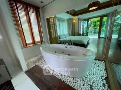 Luxurious bedroom with in-room bathtub and scenic view, perfect for relaxation and comfort.