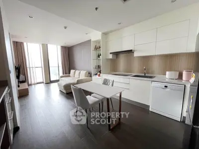 Modern open-layout kitchen and living area with sleek design and natural light.