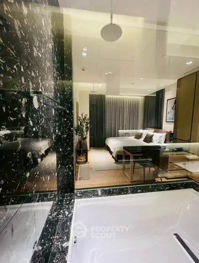 Luxurious bedroom with marble-accented ensuite bathroom and elegant decor