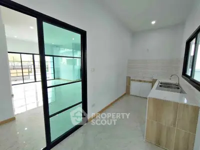 Modern kitchen with sleek sliding glass doors and ample natural light
