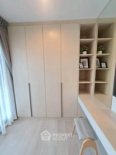 Modern bedroom with built-in wardrobe and cozy seating area