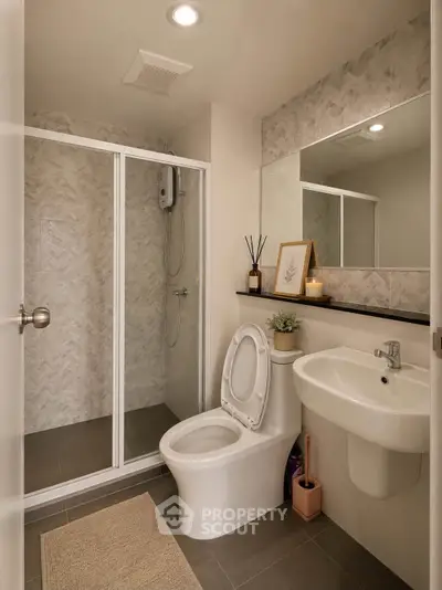 Modern bathroom with shower enclosure and sleek fixtures in a contemporary home.