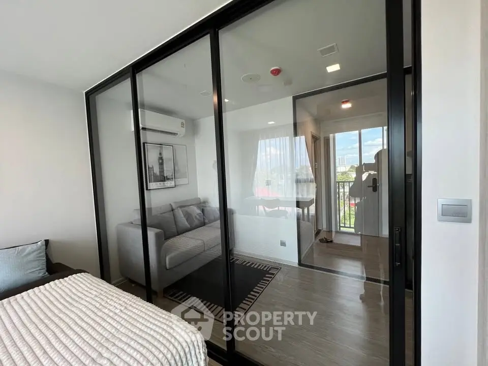 Modern apartment with glass partition and cozy living area