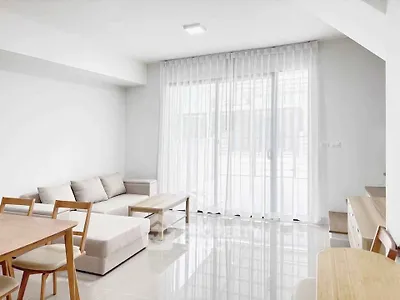 Bright modern living room with sleek furniture and large windows for natural light.