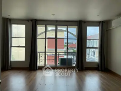 Spacious room with large windows offering a scenic view, perfect for natural light lovers.