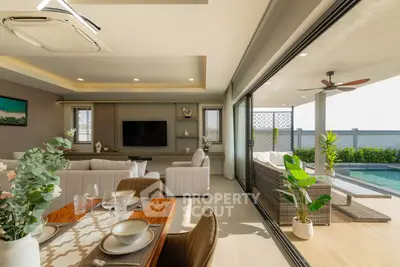 Luxurious open-plan living room with poolside view and elegant dining area