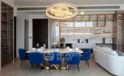 Luxurious modern dining room with elegant chandelier and blue velvet chairs