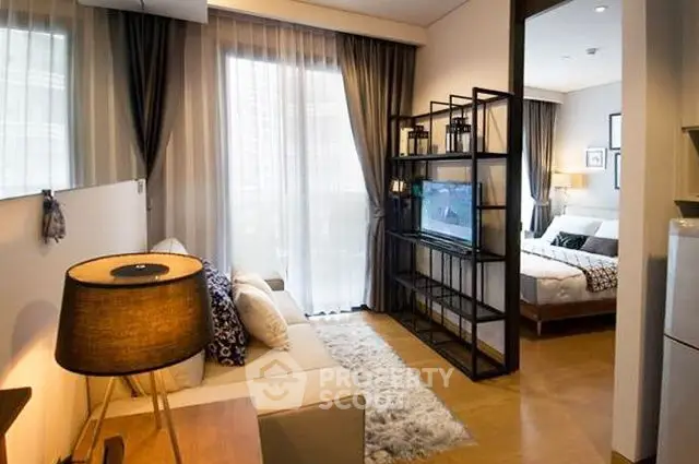 Modern living room with cozy sofa and stylish decor leading to a chic bedroom.