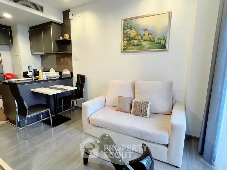 Modern living room with cozy sofa and stylish kitchen in open layout apartment.
