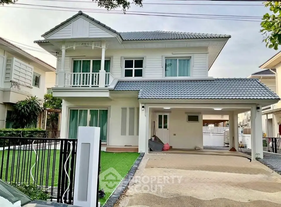 Charming two-story house with modern design and spacious driveway in a serene neighborhood.